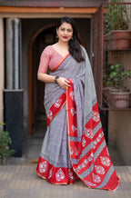 Grey/red ajrakh style saree.