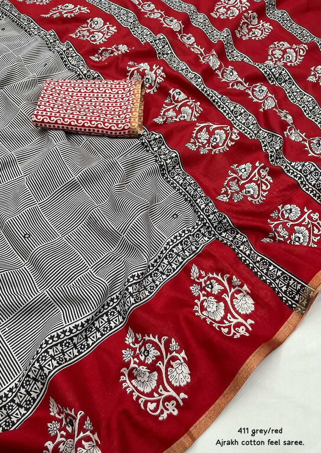 Grey/red ajrakh style saree.