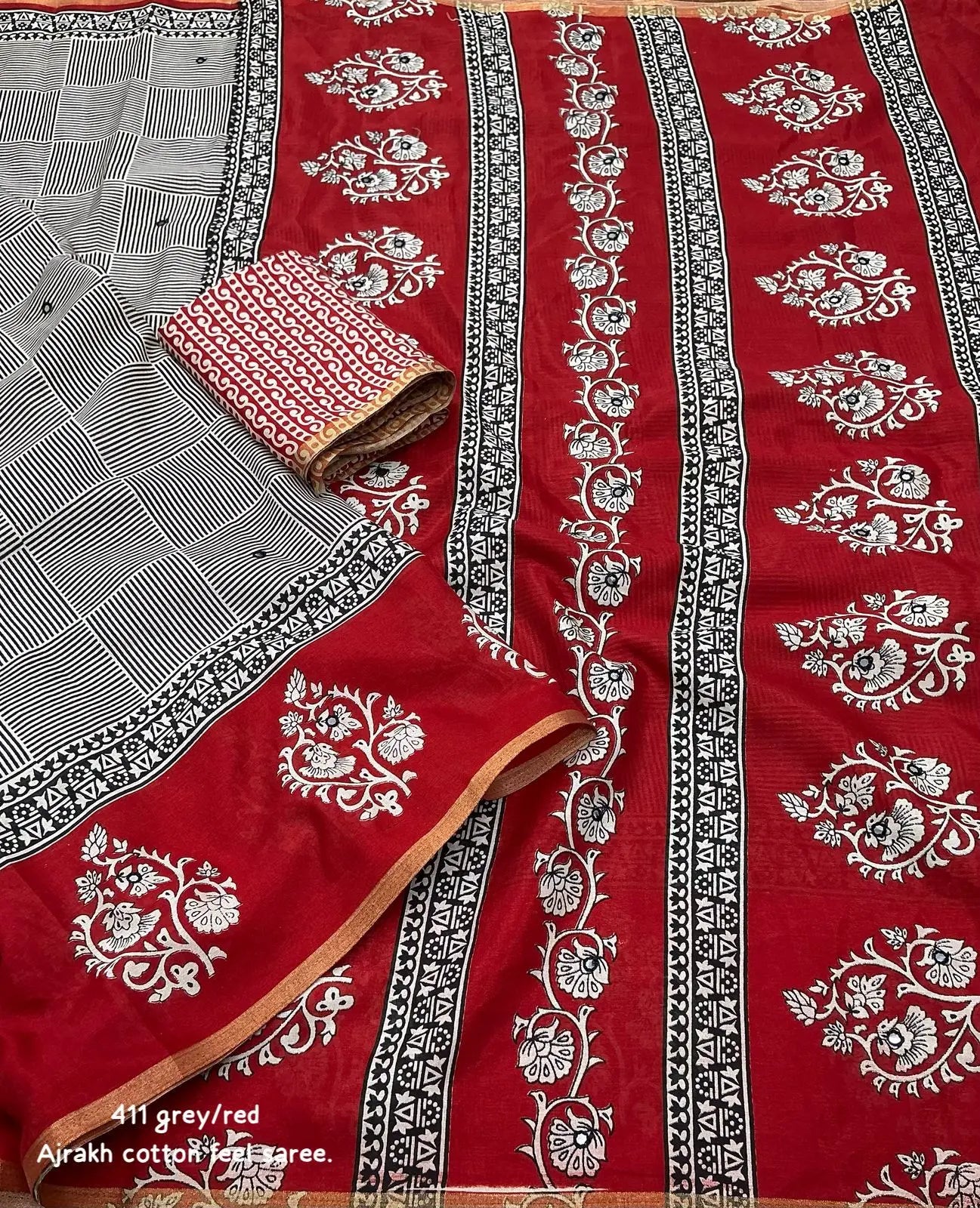 Grey/red ajrakh style saree.