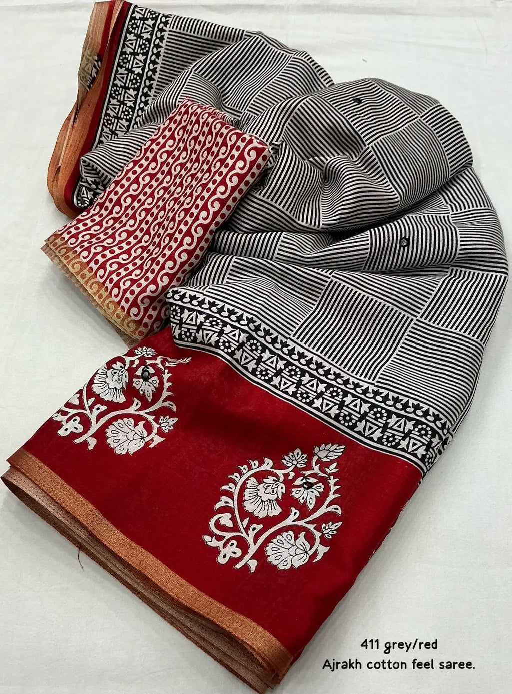 Grey/red ajrakh style saree.