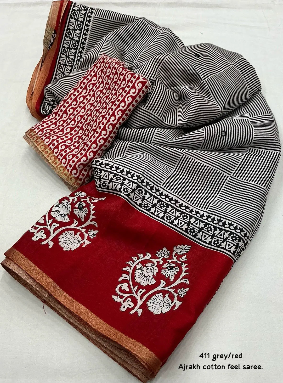 Grey/red ajrakh style saree.