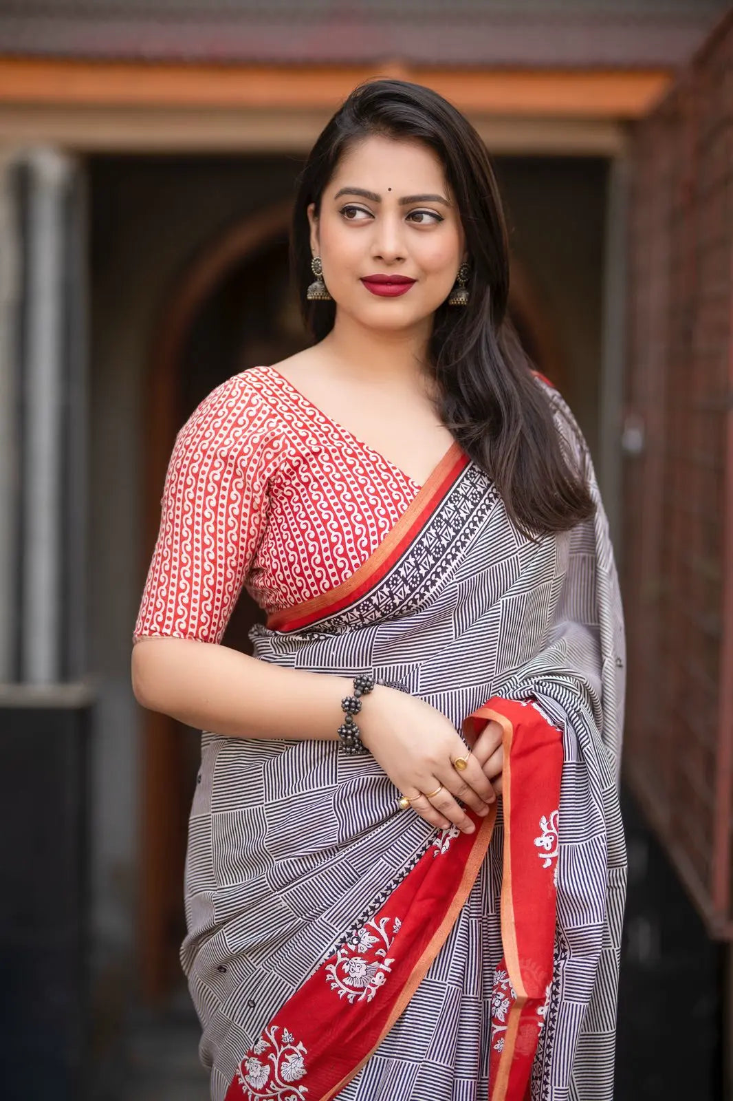 Grey/red ajrakh style saree.